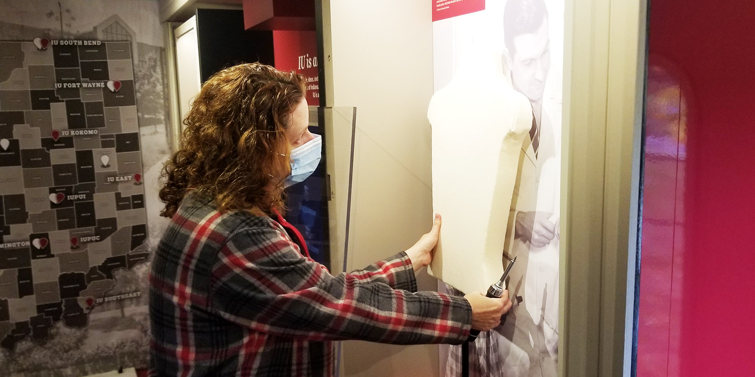 Heather Calloway, Executive Director of Collections, installing an exhibit.